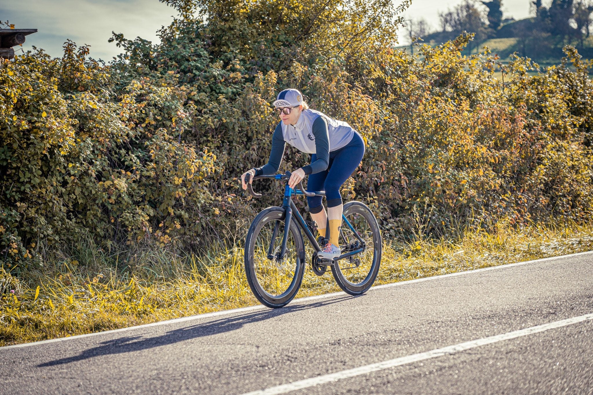 A cyclist on an open road in the Lessinia hills